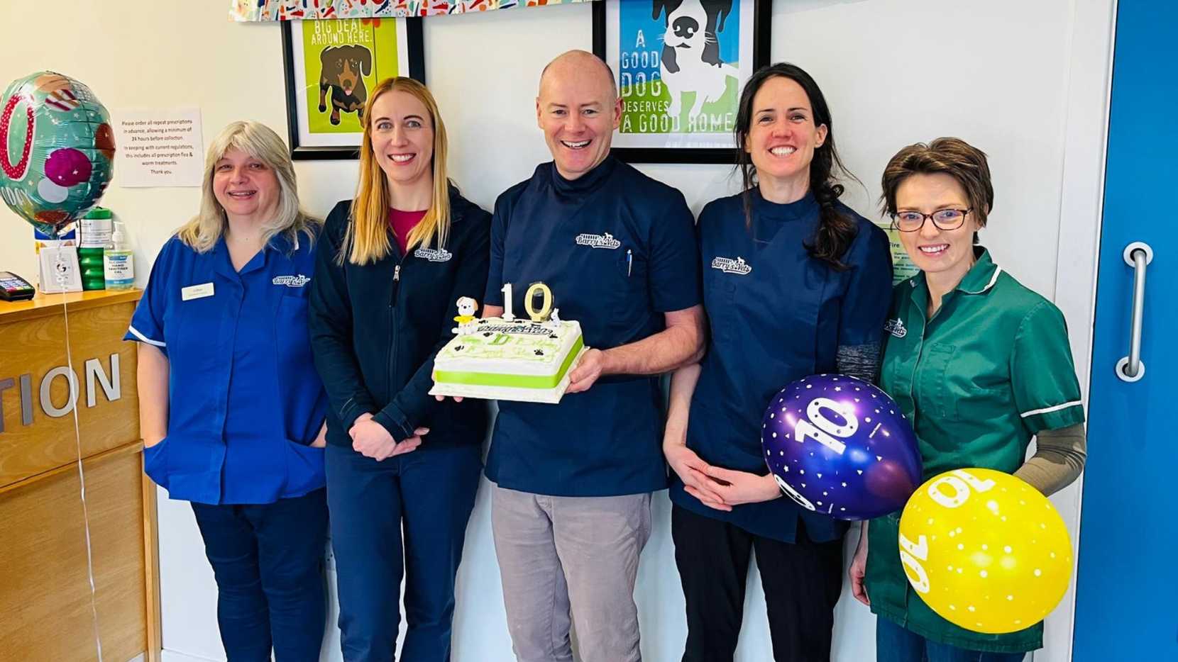 The team at Barry's vets with balloons and a cke